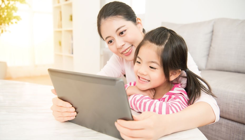 mom with child looking at a tablet