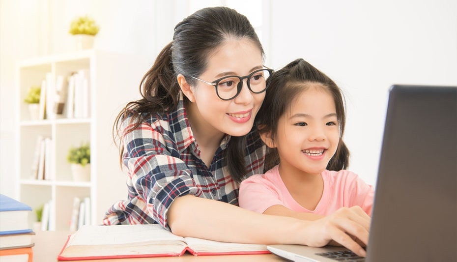 mother with kid infront of a laptop