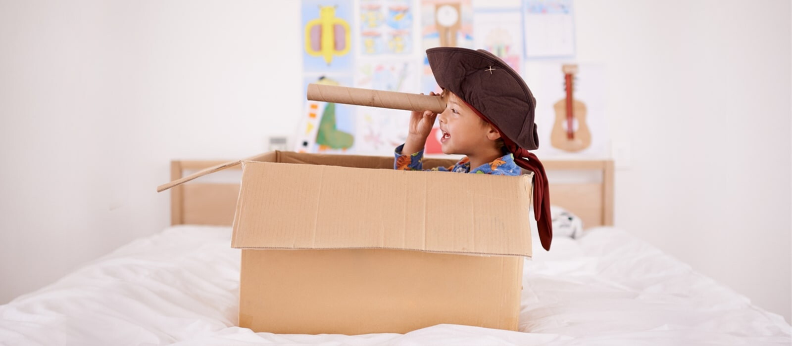 boy with pirate costume in a box